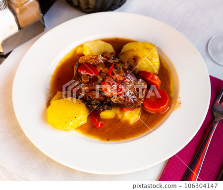 Baked lamb shoulder with vegetables Baked lamb shoulder with vegetables 106304147