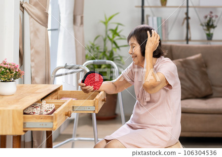 Elderly woman found her lost wallet in drawer.  Dementia concept. 106304536