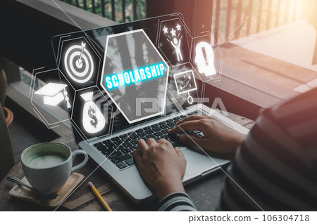Scholarship concept, Person worjing on laptop computer with scholarship icon on virtual screen. Scholarship concept, Person worjing on laptop computer with scholarship icon on virtual screen. 106304718