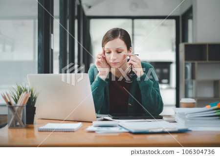 Overworked businesswoman suffering from headache and thinking how to end work. 106304736