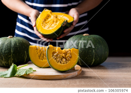 Green pumpkin with hand for cooking, Organic vegetable in autumn season Green pumpkin with hand for cooking, Organic vegetable in autumn season 106305974