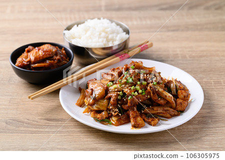Korean stir fried kimchi cabbage with pork eating with kimchi and cooked rice on wooden table Korean stir fried kimchi cabbage with pork eating with kimchi and cooked rice on wooden table 106305975