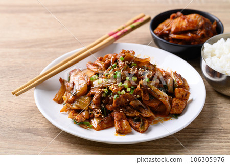 Korean stir fried kimchi cabbage with pork eating with kimchi and cooked rice on wooden table Korean stir fried kimchi cabbage with pork eating with kimchi and cooked rice on wooden table 106305976