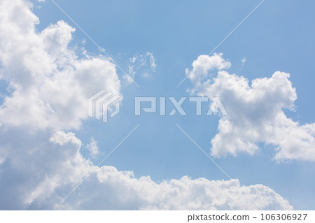 White puffy clouds over the blue sky on a sunny day. White puffy clouds over the blue sky on a sunny day. 106306927