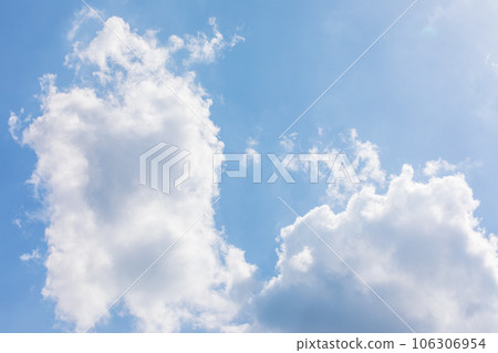 White puffy clouds over the blue sky on a sunny day. 106306954