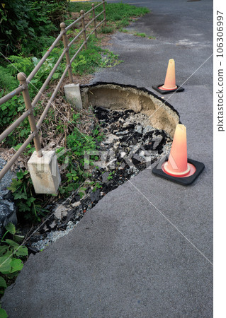 road damaged by natural disaster 106306997