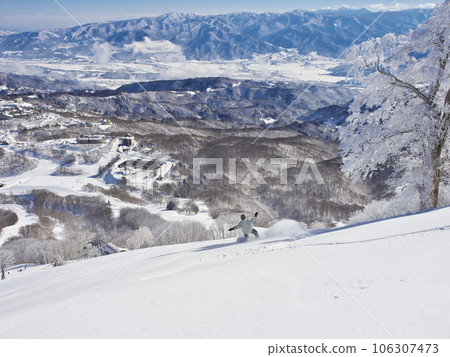冬季的斑尾高原滑雪場 單板滑雪者在未壓實的上部巨型滑雪道上滑雪 冬季的斑尾高原滑雪場 單板滑雪者在未壓實的上部巨型滑雪道上滑雪 106307473