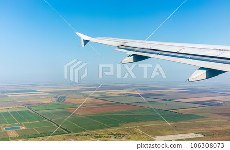 View from the airplane window during taking off on a clear summer morning 106308073