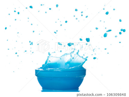 Blue paint water spill splash in bowl cup. Blue liquid lotion moisturizer cosmetic pour float in mid air. Blue cocktail drink explosion throw fluttering. White background isolated high speed shutter Blue paint water spill splash in bowl cup. Blue liquid lotion moisturizer cosmetic pour float in mid air. Blue cocktail drink explosion throw fluttering. White background isolated high speed shutter 106309848