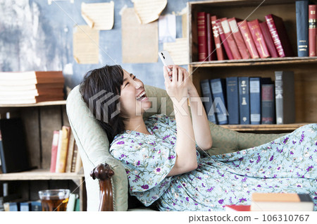 Young woman smartphone search smile image Young woman smartphone search smile image 106310767