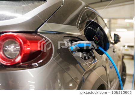 Recharging electric cars at the charging station in the underground parking. 106310905