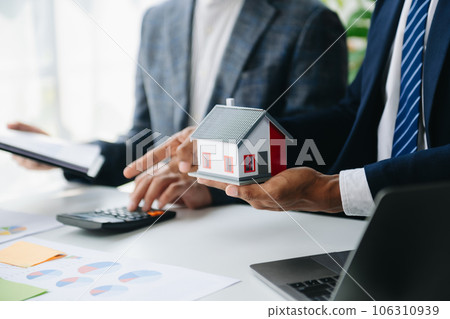 Salesman Hands On House Model , Small Toy House Small Mortgage Property insurance and concepts real estate. 106310939