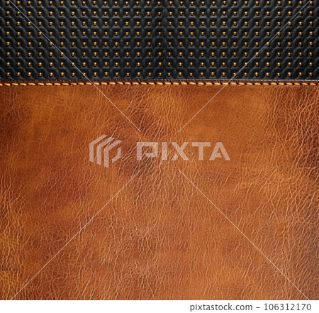 Leather background of brown and black colors with bronze rivets. Decorative backdrop with brown and black color cowhide texture.  Copy space for text 106312170