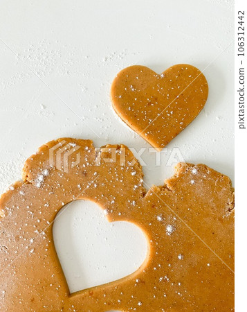 The process of cooking heart cookies. Top view raw 106312442