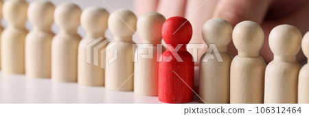 Red wooden figure in a number of white figures in a row Red wooden figure in a number of white figures in a row 106312464