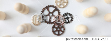 Metal gears and white wooden figures, shallow focus Metal gears and white wooden figures, shallow focus 106312465