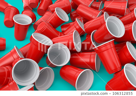 Heap of disposable utensils like plate, folk, spoon,knife and cup on green 106312855