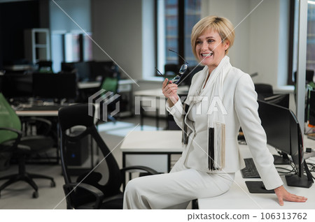 Business woman sitting at the desktop in the office. Business woman sitting at the desktop in the office. 106313762