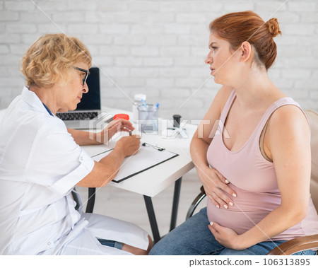 Unhappy pregnant woman at the doctor's appointment. 106313895