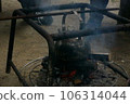 warm the kettle on the bonfire 106314044