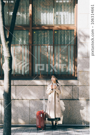 A woman with a smartphone while traveling 106314661