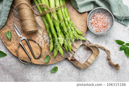 Bunch of raw asparagus stems with different spices Bunch of raw asparagus stems with different spices 106315186