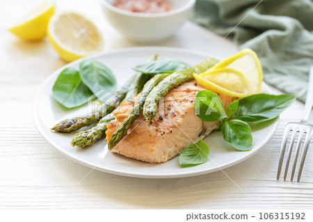 Baked Delicious salmon, green asparagus on plate Baked Delicious salmon, green asparagus on plate 106315192