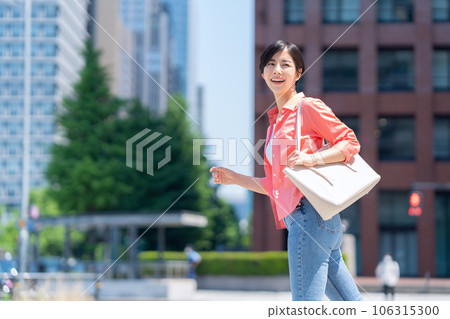 Young woman in office casual commuting to office district Young woman in office casual commuting to office district 106315300