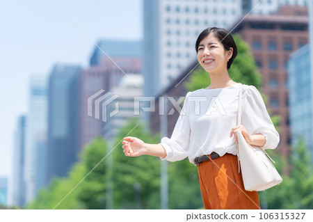 Young business woman in office casual commuting to office district 106315327