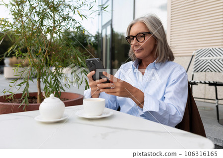 business portrait of a successful senior woman with gray hair and glasses dressed in a shirt waiting business portrait of a successful senior woman with gray hair and glasses dressed in a shirt waiting 106316165