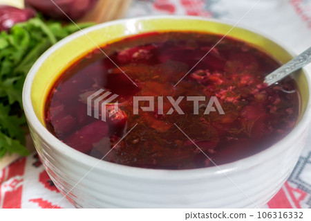 Ukrainian borscht in a ceramic plate on the kitchen table. 106316332