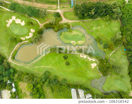 Aerial view drone shot of beautiful green golf field fairway and putting green,Top down image for sport background and travel background Aerial view drone shot of beautiful green golf field fairway and putting green,Top down image for sport background and travel background 106316542