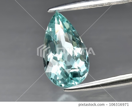 Natural gem blue tourmaline on a gray background 106316971