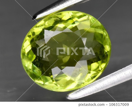 Natural gemstone green tourmaline on gray background Natural gemstone green tourmaline on gray background 106317009