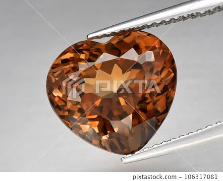 Natural gemstone orange topaz on a gray background. Imperial topaz, champagne topaz Natural gemstone orange topaz on a gray background. Imperial topaz, champagne topaz 106317081
