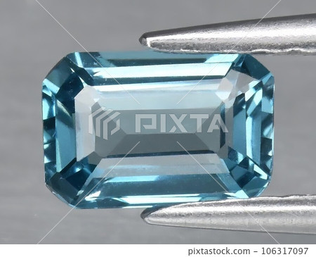 Natural gemstone blue topaz on a gray background Natural gemstone blue topaz on a gray background 106317097