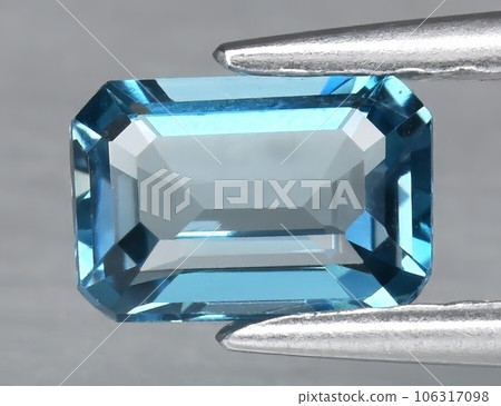 Natural gemstone blue topaz on a gray background 106317098