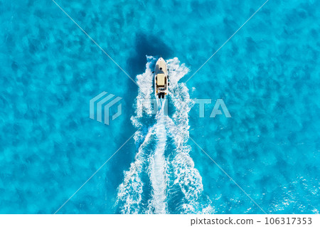 Vacation and leisure. Aerial view on fast boat on blue Mediterranean sea at sunny day. Vacation and leisure. Aerial view on fast boat on blue Mediterranean sea at sunny day. 106317353