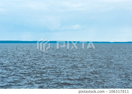 waterscape of Lake Onega, the silhouette of longship is visible in the distance waterscape of Lake Onega, the silhouette of longship is visible in the distance 106317811