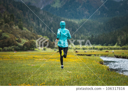 Woman trail runner cross country running in beautiful nature 106317816