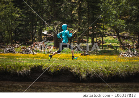 Woman trail runner cross country running in beautiful nature Woman trail runner cross country running in beautiful nature 106317818