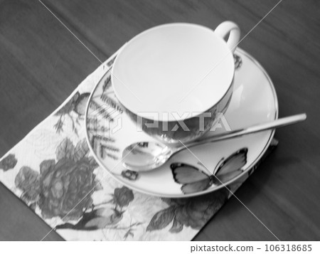 Empty coffeecup standing on wooden table for dark tasty coffee Empty coffeecup standing on wooden table for dark tasty coffee 106318685