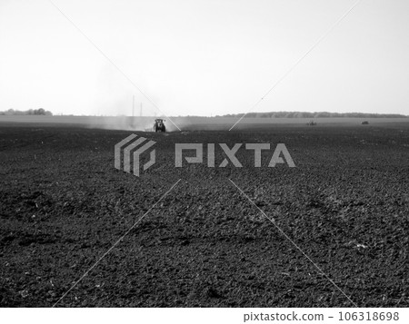 Plowed field by tractor in black soil on open countryside nature 106318698