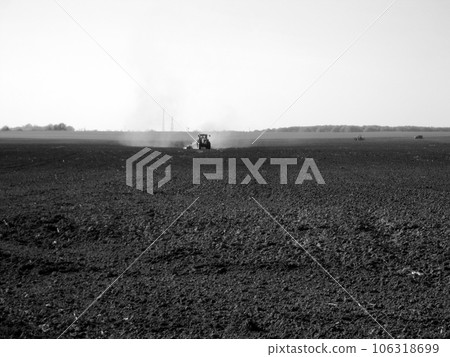 Plowed field by tractor in black soil on open countryside nature 106318699