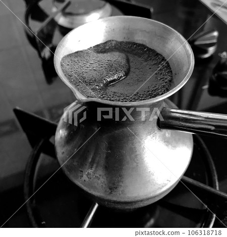 Barista preparing hot tasty drink from copper turk 106318718