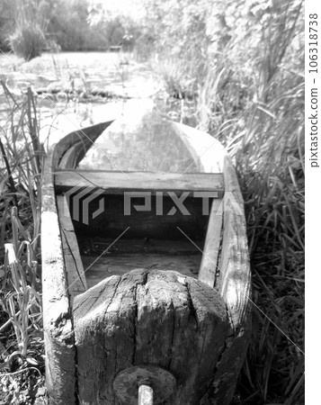 Old wooden broken boat for swimming on banks water in natural reeds Old wooden broken boat for swimming on banks water in natural reeds 106318738