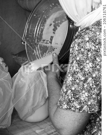 Photo on theme of milkmaid woman pouring milk 106318761