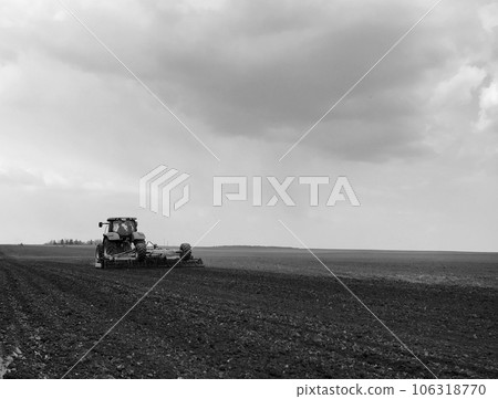 Plowed field by tractor in black soil on open countryside nature Plowed field by tractor in black soil on open countryside nature 106318770