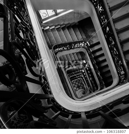 View bottom up on beautiful luxury staircase with wooden railings View bottom up on beautiful luxury staircase with wooden railings 106318807
