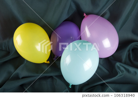 balloons in harmonious colors on a wavy green background balloons in harmonious colors on a wavy green background 106318940